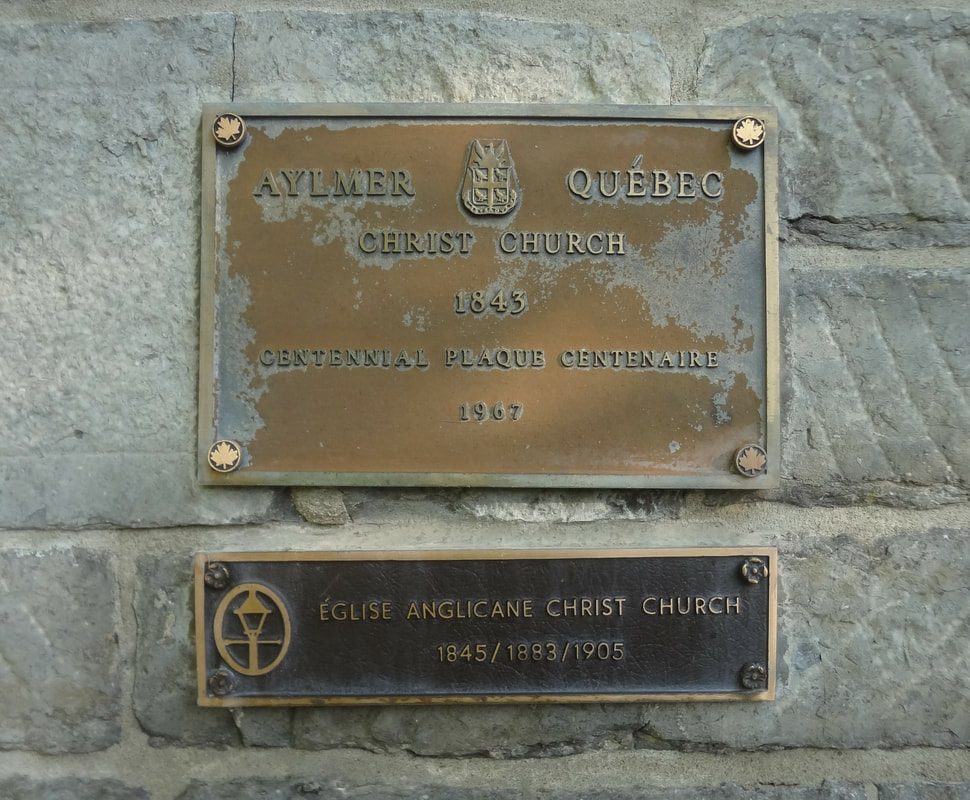 Historic plaques on Christ Church Aylmer showing the church's founding dates and centennial commemoration